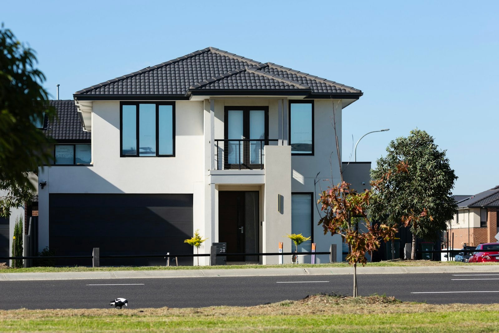 Two-story house with a dark double garage door
